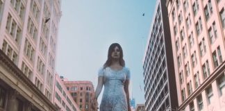 Uma gigante Lana Del Rey caminha pelas ruas no videoclipe de “Doin’ Time”